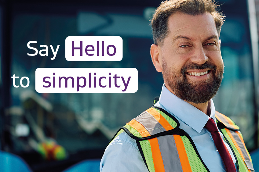 An image of a smiling bus operator in front of a vehicle. A text overlay reads 