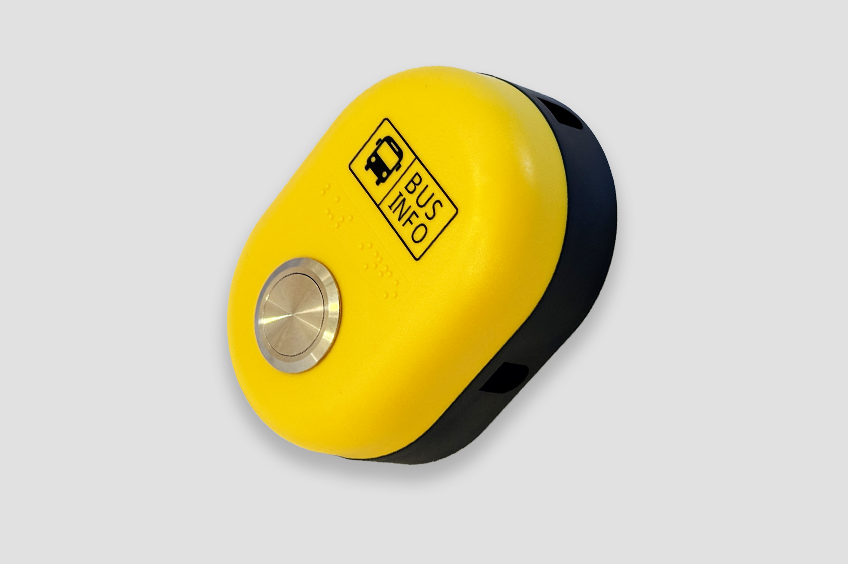 A high-visibility button with text, icon and braille identifiers.
