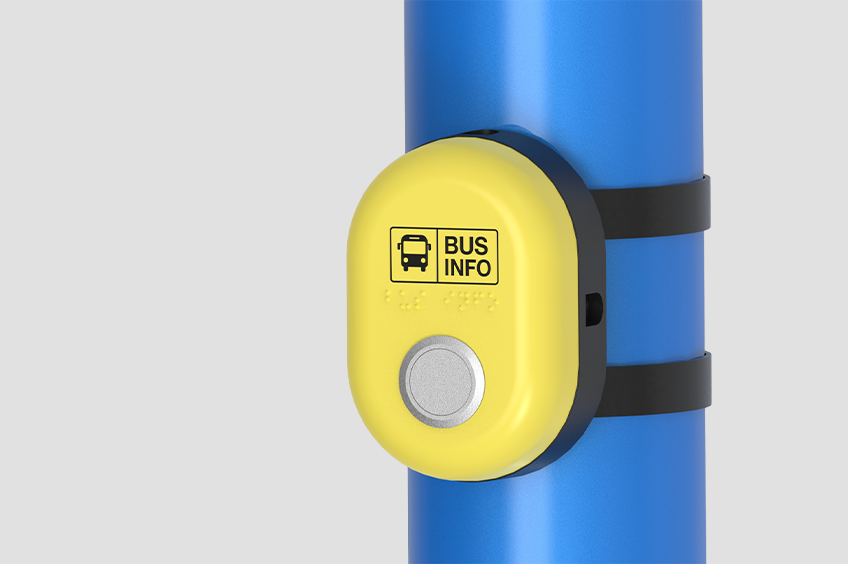 A render of the Journeo Push Button Audio. A high-visibility button with text, icon and braille identifiers, installed on a pole.